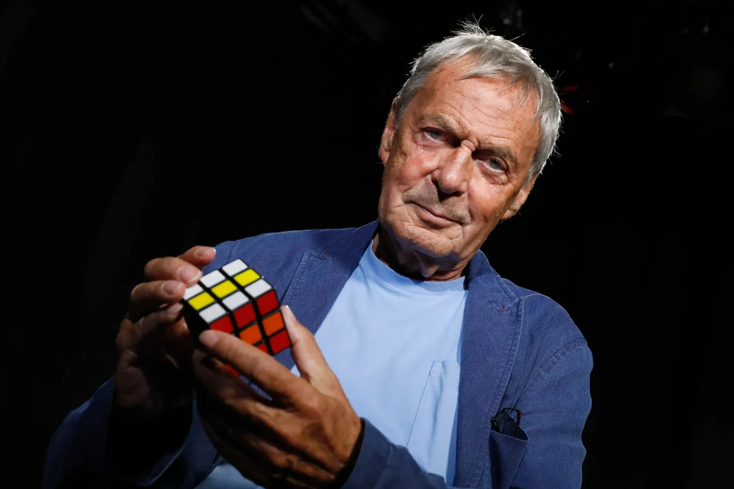 Professor Erno Rubik holding a Rubik's Cube
